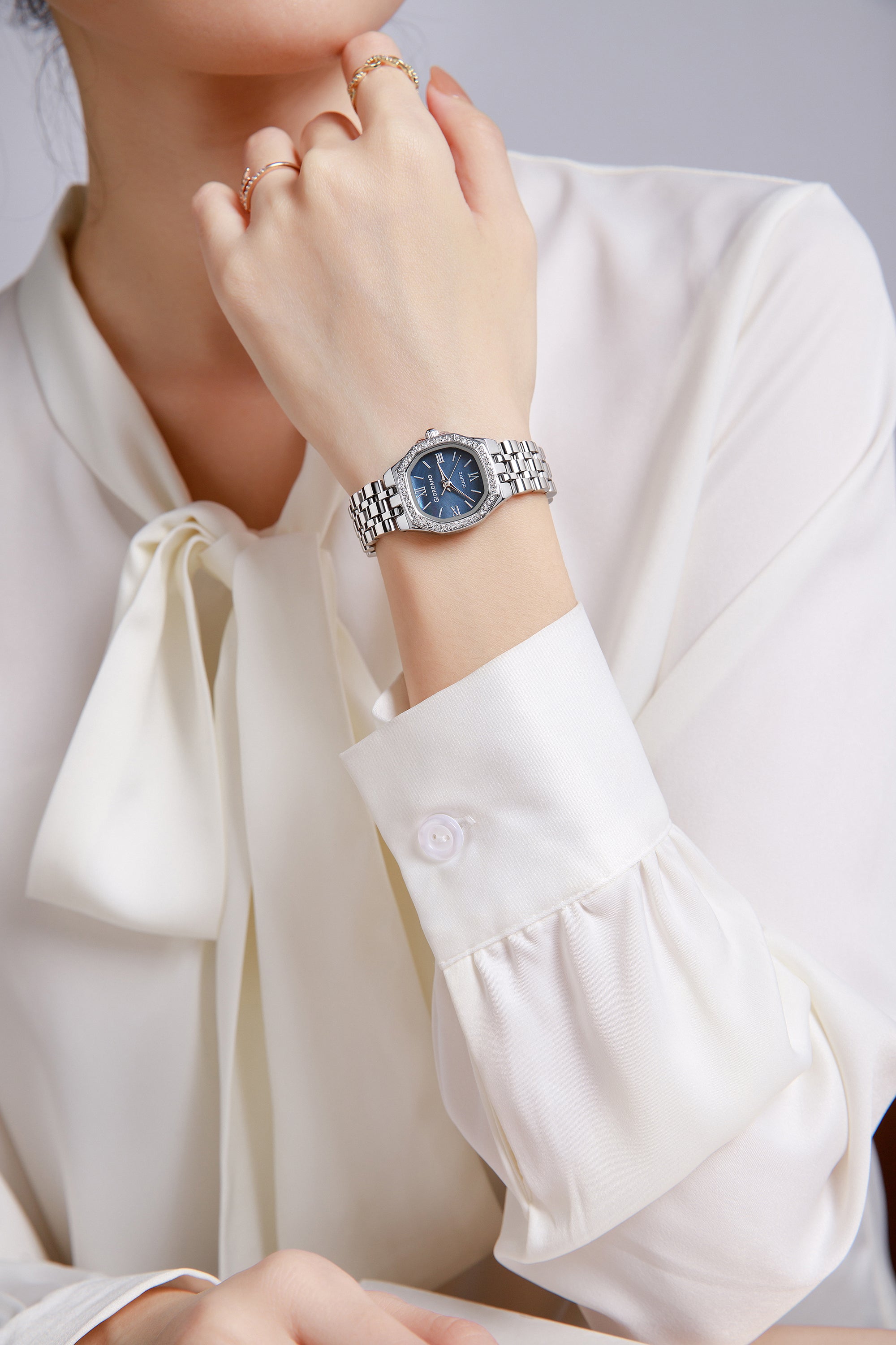 Giordano Analog Quartz Watch for Women with Round Blue Dial, Crystal Studded Bezel, Roman Markers and Stainless Steel Strap - GZ-60162-11